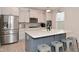 Modern kitchen with a quartz countertop island and stainless steel appliances at 655 Bracknell Dr, Avon, IN 46123