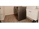 Modern laundry room with front-loading washer and dryer and a utility sink at 655 Bracknell Dr, Avon, IN 46123