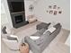 Open-concept living room featuring fireplace, hardwood floors, stylish furniture, and ample natural light at 655 Bracknell Dr, Avon, IN 46123