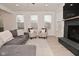 Bright living room featuring neutral tones, a fireplace, large windows, and comfortable seating at 655 Bracknell Dr, Avon, IN 46123