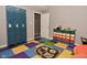 Playroom equipped with lockers, colorful storage bins, and a playful rug, designed for organization and fun at 655 Bracknell Dr, Avon, IN 46123