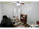 This bedroom has hard surface floors, neutral walls, and a ceiling fan with lighting at 6900 W Georgetown Rd, Columbus, IN 47201