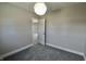 Cozy gray bedroom featuring plush carpet and an open door at 6900 W Georgetown Rd, Columbus, IN 47201
