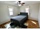 Comfortable bedroom with hardwood floors, ceiling fan, and a large window for natural light at 6900 W Georgetown Rd, Columbus, IN 47201