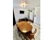 Dining area with tile floors, wood table, television, and guitar at 6900 W Georgetown Rd, Columbus, IN 47201