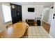 Dining area with tile floors, wood table, television, guitar, and hutch at 6900 W Georgetown Rd, Columbus, IN 47201