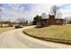 Exterior view of a brick home with long driveway and multiple parked cars at 6900 W Georgetown Rd, Columbus, IN 47201