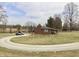 Charming brick home features a covered porch, circle driveway, and a spacious yard at 6900 W Georgetown Rd, Columbus, IN 47201