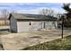 Exterior view of a home with vinyl siding, French doors, a concrete patio and basketball hoop at 6900 W Georgetown Rd, Columbus, IN 47201