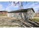 Exterior view of vinyl siding, concrete patio, French doors and a fenced-in area at 6900 W Georgetown Rd, Columbus, IN 47201