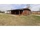 Well-maintained single-story brick home featuring a wide covered front porch and manicured landscaping at 6900 W Georgetown Rd, Columbus, IN 47201