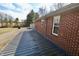 Exterior shot showing the side of the brick house with a view of the long roof at 6900 W Georgetown Rd, Columbus, IN 47201
