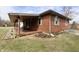 Charming brick home featuring a covered porch and lush landscaping at 6900 W Georgetown Rd, Columbus, IN 47201