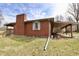 Brick home with back deck and covered porch featuring a brick chimney at 6900 W Georgetown Rd, Columbus, IN 47201