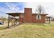 Exterior view of home with back deck, covered porch, and adjacent parking at 6900 W Georgetown Rd, Columbus, IN 47201
