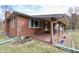 Brick home featuring a welcoming covered front porch with decorative flower pots at 6900 W Georgetown Rd, Columbus, IN 47201