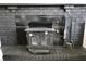 Interior shot showing a close up of a black brick fireplace with a black wood burning stove at 6900 W Georgetown Rd, Columbus, IN 47201