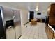 Kitchen with stainless steel refrigerator and brown cabinets overlooking the dining area at 6900 W Georgetown Rd, Columbus, IN 47201