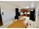 Traditional eat-in kitchen featuring wood cabinetry, black appliances, tile floors, and a table at 6900 W Georgetown Rd, Columbus, IN 47201