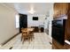 Eat-in kitchen with tile floors and view of dining area with guitar at 6900 W Georgetown Rd, Columbus, IN 47201