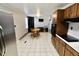 Kitchen with brown cabinetry and black appliances overlooking the dining area at 6900 W Georgetown Rd, Columbus, IN 47201