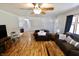 Cozy living room with neutral paint, fan, vinyl floors, and plenty of natural light at 6900 W Georgetown Rd, Columbus, IN 47201