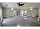 Bright and airy living room with carpet, ceiling fan, exit sign, and ample space at 6900 W Georgetown Rd, Columbus, IN 47201