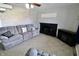 The living room boasts a decorative fireplace, plush sofa, and ample space for relaxation at 6900 W Georgetown Rd, Columbus, IN 47201