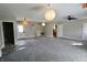 Open-concept living room showcasing gray walls, carpet, and an exit at 6900 W Georgetown Rd, Columbus, IN 47201