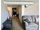 The living room boasts a decorative fireplace, plush sofa, and ample space for relaxation at 6900 W Georgetown Rd, Columbus, IN 47201