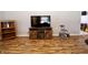 Modern entertainment center in a living room with plenty of open space and vinyl floors at 6900 W Georgetown Rd, Columbus, IN 47201