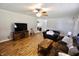 Relaxing living room features a ceiling fan, vinyl floors, entertainment center, and cozy seating at 6900 W Georgetown Rd, Columbus, IN 47201