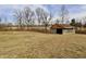 View of the outbuilding on the property with a lush field and sky background at 6900 W Georgetown Rd, Columbus, IN 47201