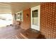 Charming covered porch features a bench, welcoming entrance, and brick accents at 6900 W Georgetown Rd, Columbus, IN 47201