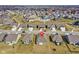 An aerial view of a neighborhood featuring houses with large yards, trees, and community streets at 7326 Wooden Grange Dr, Indianapolis, IN 46259