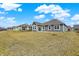 The backyard and rear elevation of the home next to other similar homes in the community at 7326 Wooden Grange Dr, Indianapolis, IN 46259
