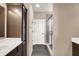 Bathroom features wood look flooring, a shower with glass door, and a storage cabinet at 7326 Wooden Grange Dr, Indianapolis, IN 46259