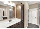 Bathroom includes wood look flooring, vanity, mirror and glass shower at 7326 Wooden Grange Dr, Indianapolis, IN 46259