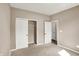 A cozy bedroom with neutral tones, plush carpet, closet, and a doorway leading to the rest of the home at 7326 Wooden Grange Dr, Indianapolis, IN 46259