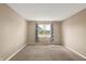 An empty bedroom with carpet and a window for natural light at 7326 Wooden Grange Dr, Indianapolis, IN 46259