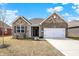 Charming single-Gathering home with brick exterior, a two-car garage, and a well-maintained front yard at 7326 Wooden Grange Dr, Indianapolis, IN 46259