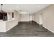 Open living room area with dark wood flooring showcasing the open concept and modern recessed lighting at 7326 Wooden Grange Dr, Indianapolis, IN 46259