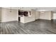 Spacious living room area with dark wood flooring showcasing the open concept and modern lighting fixtures at 7326 Wooden Grange Dr, Indianapolis, IN 46259