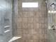 The shower has gray tile, window and built-in corner shelves at 7326 Wooden Grange Dr, Indianapolis, IN 46259