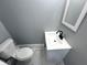 A bathroom featuring a new toilet, vanity, and mirror at 745 W 25Th St, Indianapolis, IN 46208