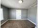 This bedroom includes neutral walls, white trim, and neutral carpet at 745 W 25Th St, Indianapolis, IN 46208