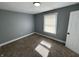 This bedroom features neutral walls and carpet at 745 W 25Th St, Indianapolis, IN 46208