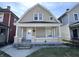 Charming home featuring a covered front porch and well-maintained exterior with neutral siding at 745 W 25Th St, Indianapolis, IN 46208