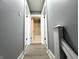 Hallway leading to bathroom with natural light and grey walls at 745 W 25Th St, Indianapolis, IN 46208