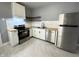 Modern kitchen featuring stainless steel appliances, white cabinets, and subway tile backsplash at 745 W 25Th St, Indianapolis, IN 46208